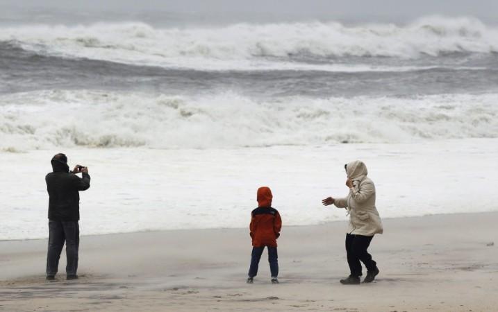 Residents from Long Island stand on beach to take photographs of the waves churned up by Hurricane Sandy in Southampton, New York Hurricane Sandy