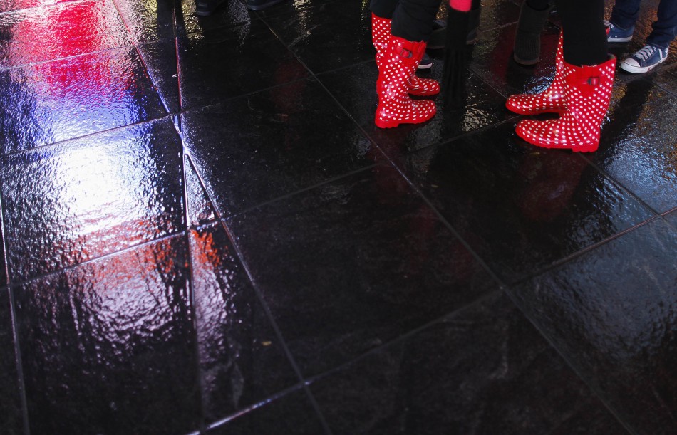 People stand in a mostly deserted Times Square wearing red rain boots ahead of Hurricane Sandy Hurricane Sandy