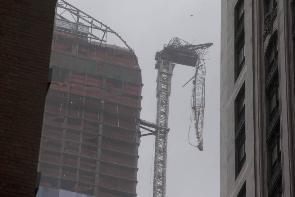 A collapsed crane dangles beside a building under construction, as Hurricane Sandy made its approach, in New York Hurricane Sandy