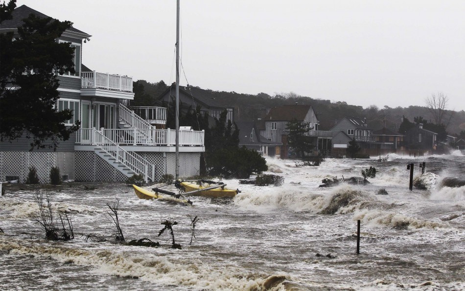 Storm surf kicked up by the high winds from Hurricane Sandy break onto homes in Southampton, New York Hurricane Sandy