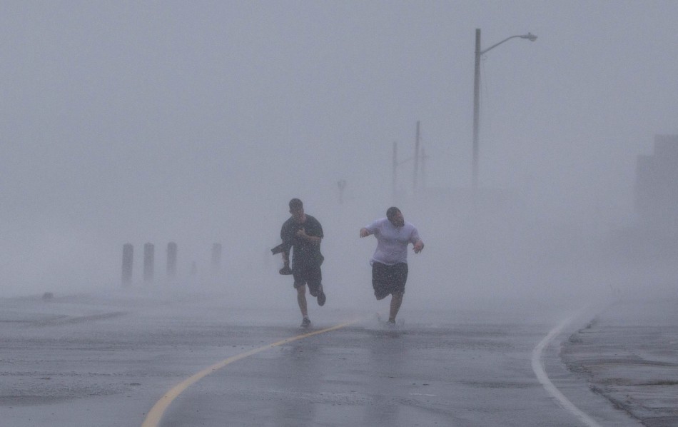 Two boys run down Foster Avenue while dodging high winds and waves from the effects of Hurricane Sandy in Marshfield, Massachusetts Hurricane Sandy