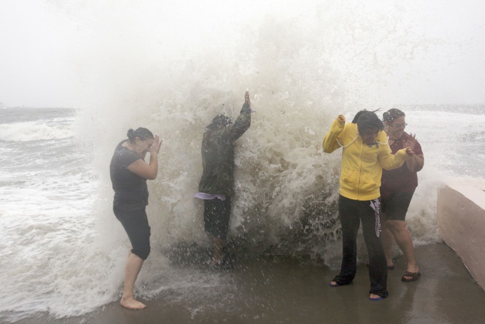 Denitsa Nakova Abraham Robles Laura Carrasco and Marilyn Rodriguez let the waves wash over them in Milford, Connecticut as Hurricane Sandy approaches the area Hurricane Sandy