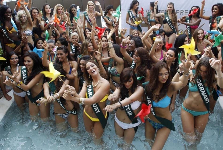 Candidates of the Miss Earth beauty contest, holding pinwheels to promote sustainable energy, dance during a media presentation at a hotel in Taguig City Miss Earth 2012
