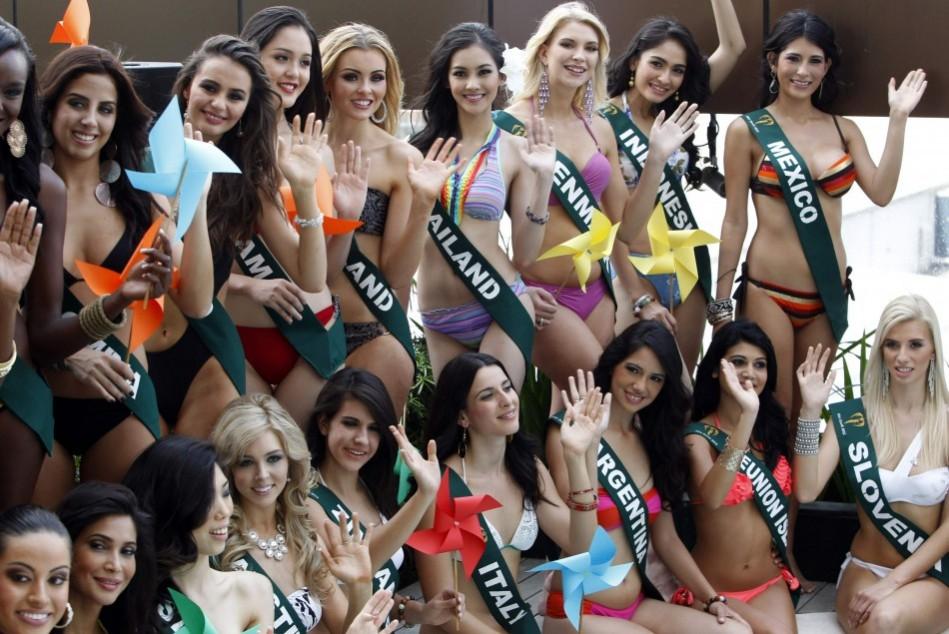 Candidates of the Miss Earth beauty contest, holding pinwheels to promote sustainable energy, wave to photographers during a media presentation at a hotel in Taguig City Miss Earth 2012