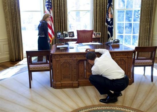 President Barack Obama examines the Barack Obama