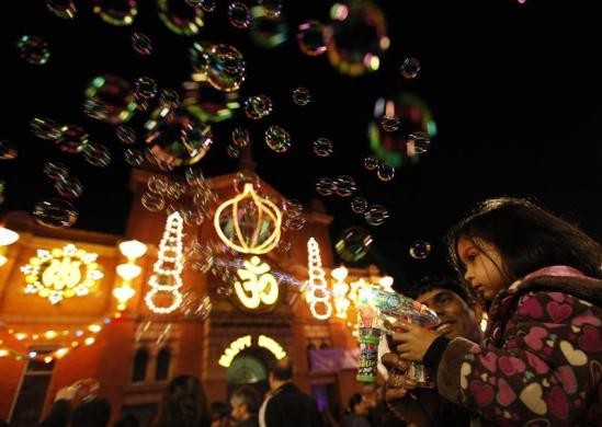 A girls shoots bubbles from a gun during the start of Diwali celebrations in Leicester, central England. Diwali Celebrations