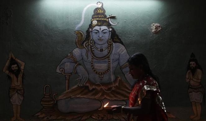 A Malaysian of Hindu faith, Puspa Ganesan, circles a temple with an oil lamp in her hands as she performs a prayer during Diwali celebrations in Kuala Lumpur. Diwali Celebrations