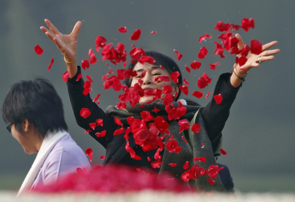 Myanmar's opposition leader Aung San Suu Kyi scatters rose petals at the memorial of India's first PM Jawaharlal Nehru in New Delhi Aung San Suu Kyi Takes A Walk Down Memory Lane, Feels Herself ‘Partly A Citizen Of India’ (PHOTOS)