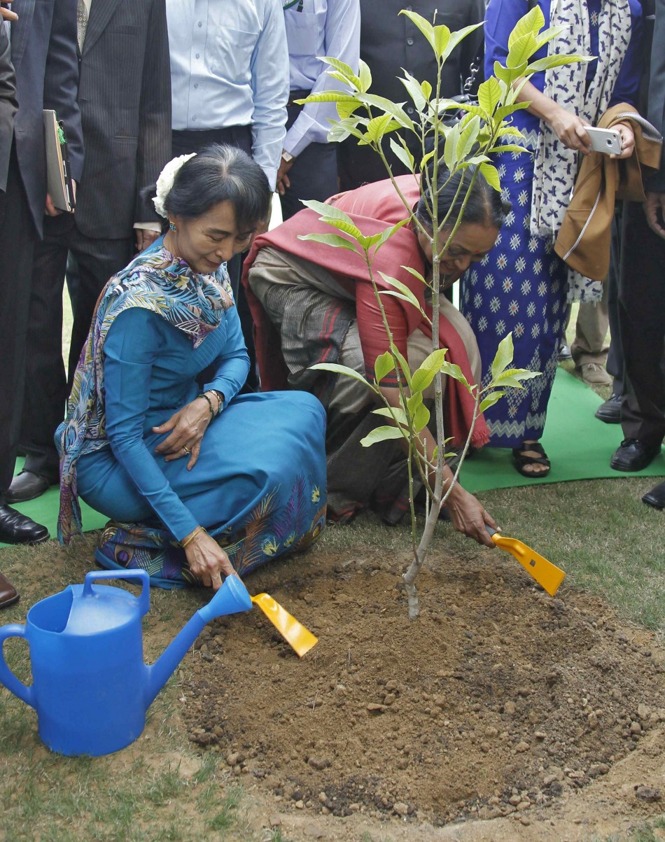 Myanmar's opposition leader Aung San Suu Kyi and Lok Sabha Speaker Meira Kumar prepare to plant a tree sapling inside the complex of Indian parliament in New Delhi. Aung San Suu Kyi Takes A Walk Down Memory Lane, Feels Herself ‘Partly A Citizen Of India’ (PHOTOS)