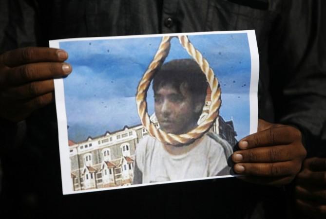A man holds a picture of Mohammad Ajmal Kasab with a noose, as he celebrates Kasab's execution, in the western Indian city of Ahmedabad November 21, 2012. Ajmal Kasab Hanged