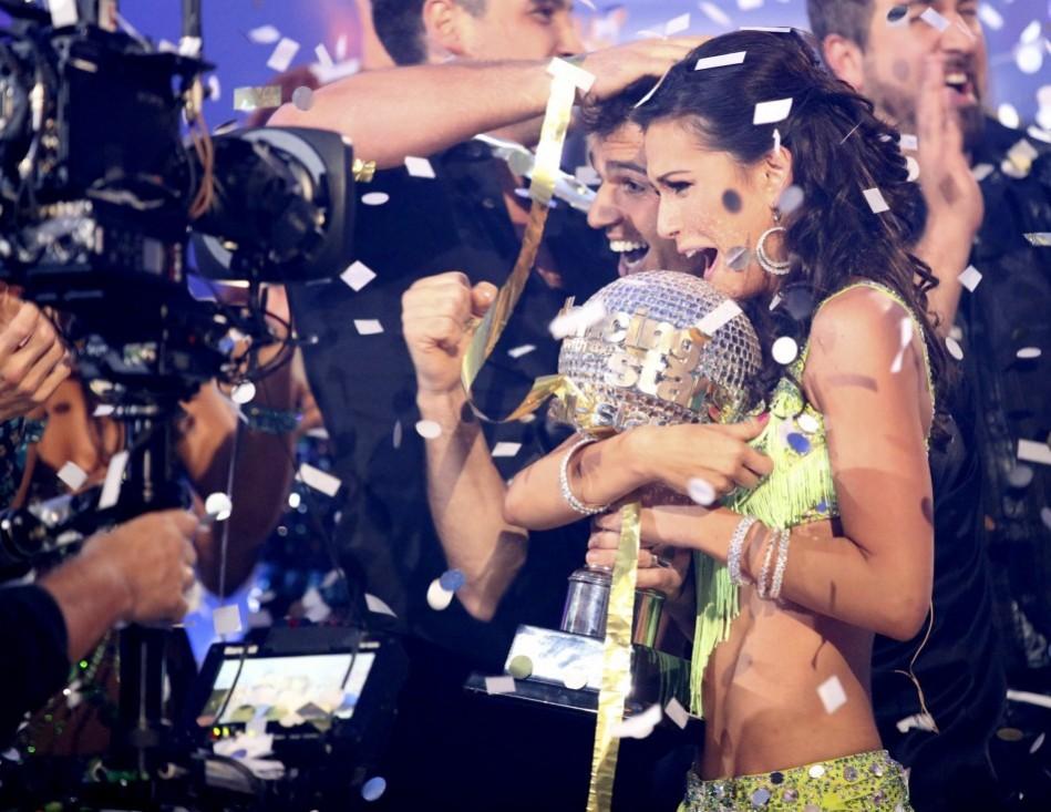 ABC publicity photograph shows contestants Rycroft and Dovolani holding mirror ball trophy as they are crowned champions on season finale of ABC's Melissa Rycroft, Tony Dovolani