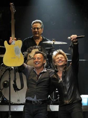 Singer Bruce Springsteen performs with Jon Bon Jovi and drummer Max Weingberg during the Bruce Springsteen, Jon Bon Jovi, Max Weingberg