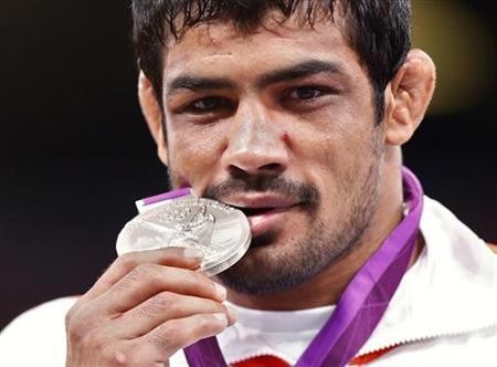 Sushil Kumar poses with his silver medal at the podium of the Men's 66Kg Freestyle wrestling at the ExCel venue during the London 2012 Olympic Games August 12, 2012.