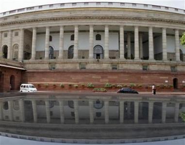 A view of the parliament building reflected in a car