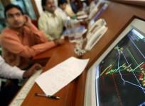 Indian stock brokers watch the key Sensex share index graph in a brokerage firm in Mumbai May 13, 2004.