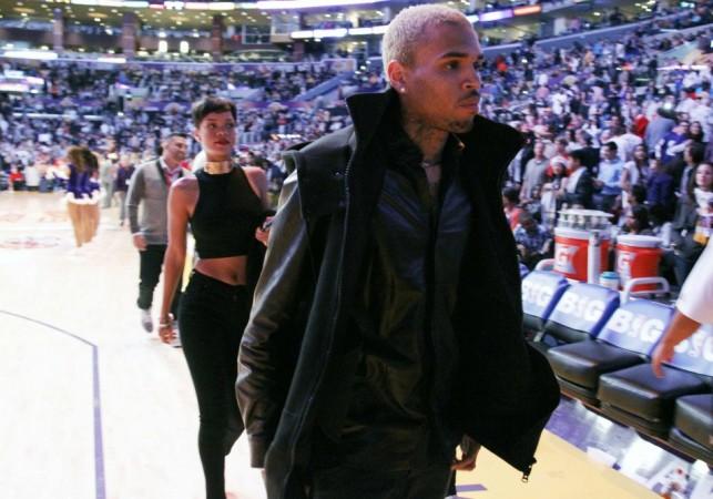 Recording artists Chris Brown and Rihanna leave the court at half time after sitting together courtside at the NBA basketball game between the New York Knicks and Los Angeles Lakers in Los Angeles Rihanna, Chris Brown