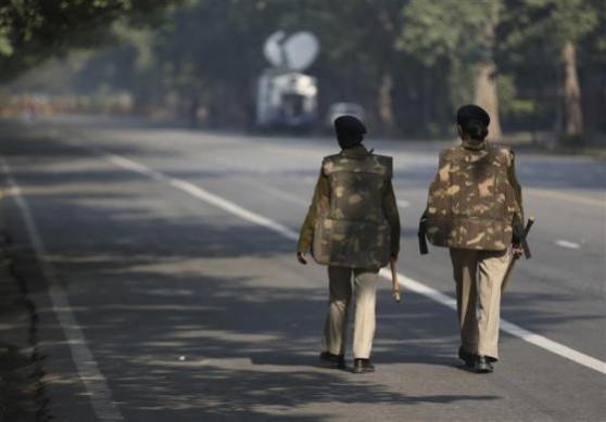 Police officers patrol a closed road leading to the India Gate in New Delhi December 29, 2012. Delhi Gang-Rape