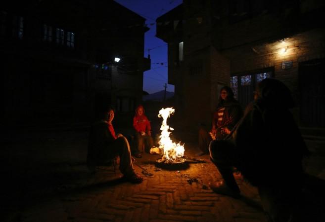 A family sits near the fire outside their house to keep warm on a cold evening at Kathmandu January 1, 2013. REUTERS/Navesh Chitrakar Cold wave in north India