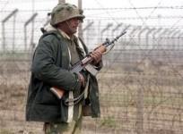 A Border Security Force (BSF) soldier patrols near the fenced border with Pakistan in Suchetgarh, southwest of Jammu, January 20, 2010.