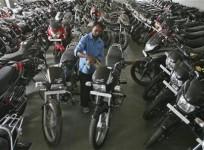 a-worker-cleans-a-hero-splendor-motorcycle-at-a-hero-motocorp-showroom-in-jammu-october-23-2012