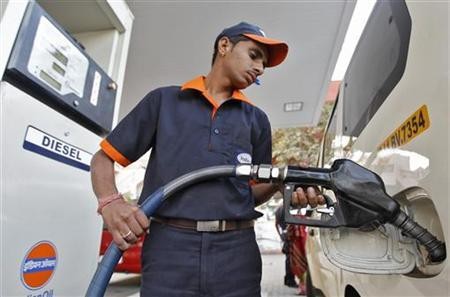 A worker fills diesel in a vehicle at a fuel station in Ahmedabad January 17, 2013.