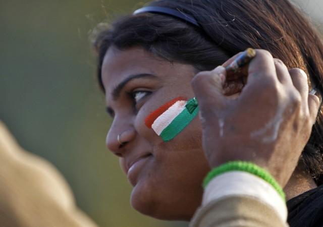 A Woman gets her face painted in tri-colours of India's national flag near the India Gate during the Republic Day celebrations in New Delhi (Reuters)