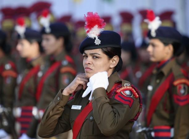Policewoman adjusts her neck scarf during the Republic Day parade in Chandigarh (Reuters)