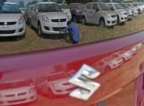a-worker-cleans-a-maruti-suzuki-swift-dzire-car-at-the-companys-stock-yard-at-sanand-in-gujarat