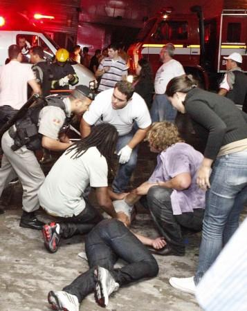 A policeman and rescues workers help a man in front of the Kiss nightclub in the southern city of Santa Maria A policeman and rescues workers help a man in front of the Kiss nightclub in the southern city of Santa Maria