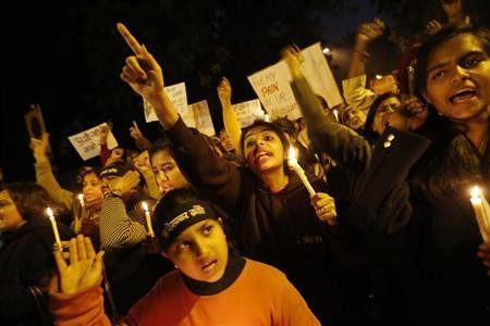 Demonstrators shout slogans and raise their hands during a candlelight march for a gang rape victim, who was assaulted in New Delhi January 16, 2013.