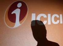 an-employees-shadow-is-cast-on-the-icici-bank-logo-at-their-headquarters-in-mumbai