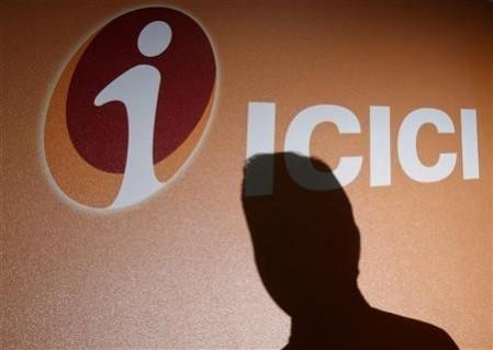 An employee's shadow is cast on the ICICI Bank logo at their headquarters in Mumbai. An employee's shadow is cast on the ICICI Bank logo at their headquarters in Mumbai.