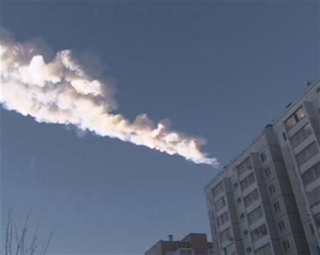 The trail of a falling object is seen above a residential apartment block in the Urals city of Chelyabinsk, in this still image taken from video shot on February 15, 2013. The trail of a falling object is seen above a residential apartment block in the Urals city of Chelyabinsk, in this still image taken from video shot on February 15, 2013.