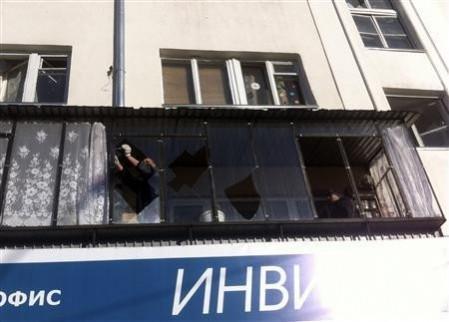 A man removes shards of glass from the frame of a broken window following sightings of a falling object in the sky in the Urals city of Chelyabinsk February 15, 2013. (Reuters) A man removes shards of glass from the frame of a broken window following sightings of a falling object in the sky in the Urals city of Chelyabinsk February 15, 2013.