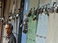 a-man-stands-in-front-of-closed-shops-during-a-nationwide-strike-in-kolkata-september-20-2012