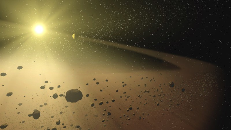 In this artist's concept, a narrow asteroid belt filled with rocks and dusty debris orbits a star similar to our own sun