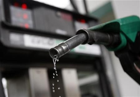 A man poses with a gasoline pump at a Budapest petrol station January 19, 2011. Gas Prices To Average Below $3 Next Year, Government Predicts
