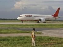a-security-personnel-stands-guard-as-air-india039s-dreamliner-boeing-787-taxies-upon-its-arrival-at-the-airport-in-new-delhi-september-8-2012