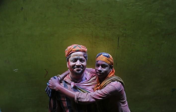 Two Hindu devotees pose for a picture during Holi celebrations in a lane near the Bankey Bihari temple in Vrindavan Holi 2013
