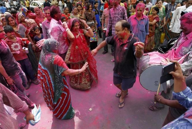 People daubed in colours dance during Holi celebrations in the western Indian city of Ahmedabad Holi 2013