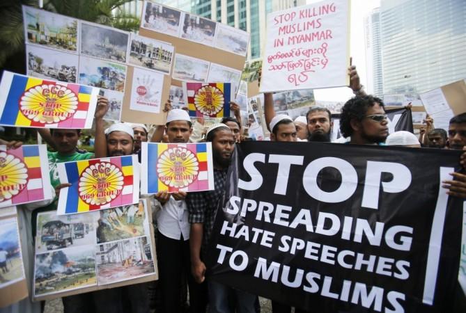 Myanmar Muslims living in Malaysia show banners and placards during a demonstration against the killings of Muslims