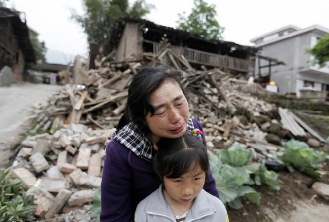 Song Zhengqiong, holding her daughter, cries in front of her damaged house after a strong 6.6 magnitude earthquake at Longmen village, Lushan county in Ya'an, Sichuan province April 21, 2013.(Reuters) Song Zhengqiong, holding her daughter, cries in front of her damaged house after a strong 6.6 magnitude earthquake at Longmen village, Lushan county in Ya'an, Sichuan province April 21, 2013.(Reuters)
