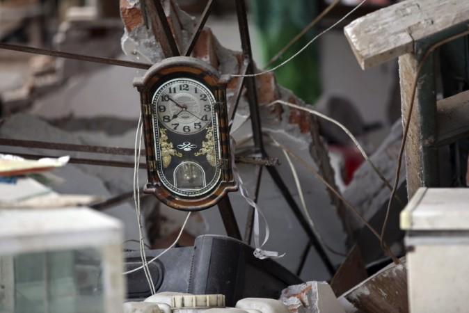 A clock is seen amidst the debris of a collapsed house after a strong 6.6 magnitude earthquake, at Longmen village, Lushan county, Ya'an, Sichuan province April 20, 2013.(Reuters) A clock is seen amidst the debris of a collapsed house after a strong 6.6 magnitude earthquake, at Longmen village, Lushan county, Ya'an, Sichuan province April 20, 2013.(Reuters)