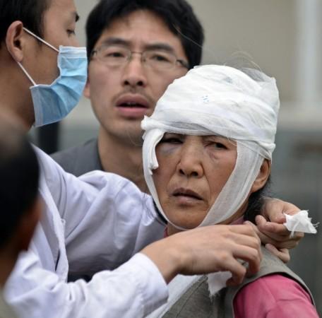 An injured woman looks up as she is being treated after a strong 6.6 magnitude earthquake hit the remote, mostly rural and mountainous Lushan county, Ya'an, Sichuan province, April 20, 2013.(Reuters) An injured woman looks up as she is being treated after a strong 6.6 magnitude earthquake hit the remote, mostly rural and mountainous Lushan county, Ya'an, Sichuan province, April 20, 2013.(Reuters)