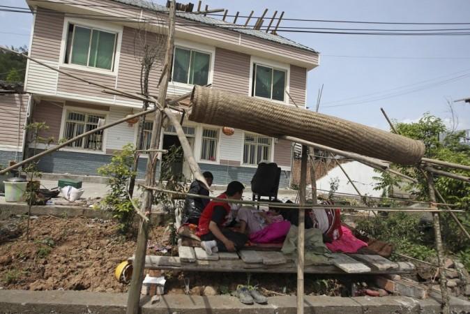 People rest in a shelter outside in case of aftershocks, following a strong 6.6 magnitude earthquake, at Longmen village, Lushan county, Ya'an, Sichuan province April 20, 2013. (Reuters) People rest in a shelter outside in case of aftershocks, following a strong 6.6 magnitude earthquake, at Longmen village, Lushan county, Ya'an, Sichuan province April 20, 2013. (Reuters)