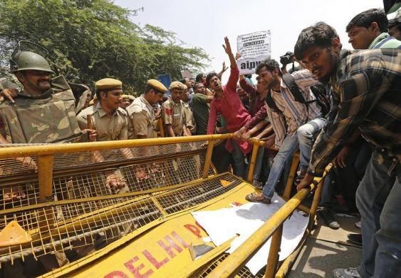 Demonstrators try to cross a police barricade during a protest outside police headquarters in New Delhi April 20, 2013. Hundreds of angry protesters gathered outside the headquarters of Delhi police on Saturday after a five year-old girl was allegedly rap