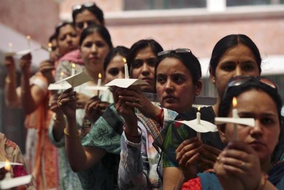 Demonstrators hold candles during a prayer meeting for a five-year-old rape victim in Jammu April 20, 2013. The girl was kept in captivity for 40 hours and allegedly raped and tortured in Delhi, police said, reviving memories of a brutal December assault