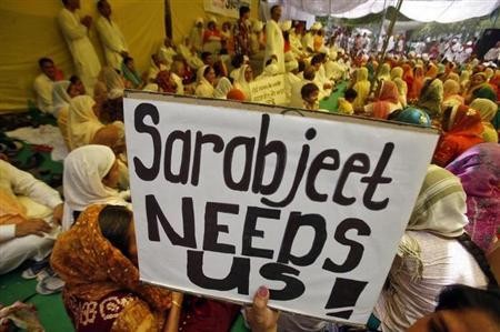 A demonstrator holds a placard during a hunger strike by Sarabjit Singh's family members demanding Singh's release from a Pakistani prison, in New Delhi May 17, 2011.