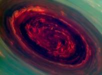 the-spinning-vortex-of-saturns-north-polar-storm-resembles-a-deep-red-rose-of-giant-proportions-surrounded-by-green-foliage-in-this-false-color-image-from-nasas-cassini-spacecraft-credit-nasa-jpl-caltech-ssi