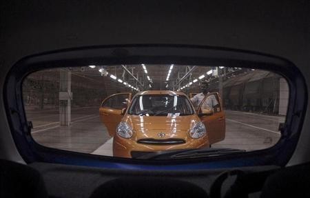 A visitor inspects the 'Micra' car inside the newly-inaugurated Renault-Nissan Alliance auto plant in Chennai March 17, 2010.